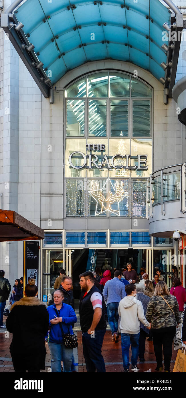 Reading, United Kingdom - December 19 2018:   Christmas shoppers outtside of the entrance to teh Oracle shoppng Centre on Broad Street Stock Photo