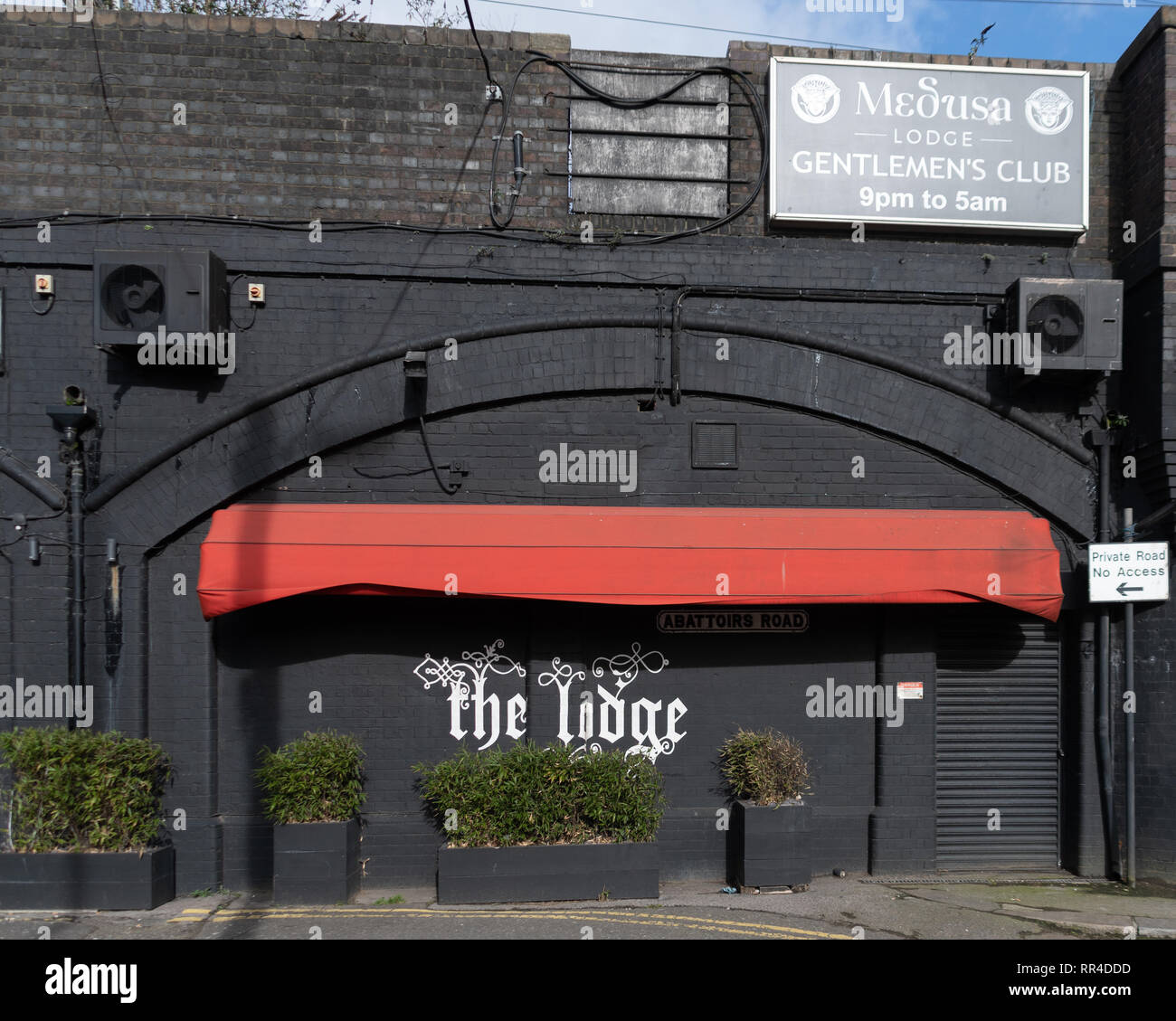 Reading, United Kingdom - February 09 2019:   The entrance to the Lodge Gentlemans club underneath the railway arches along Abattoirs Road Stock Photo