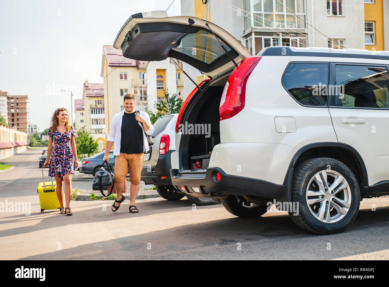 couple put bags in car trunk. road trip concept Stock Photo Alamy