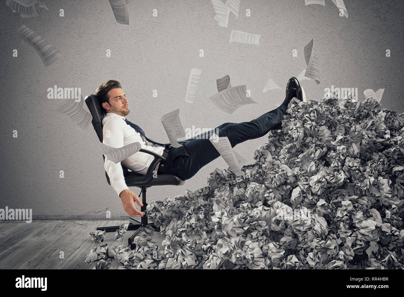 Businessman with paper sheet anywhere. Buried by bureaucracy. Concept of overwork Stock Photo