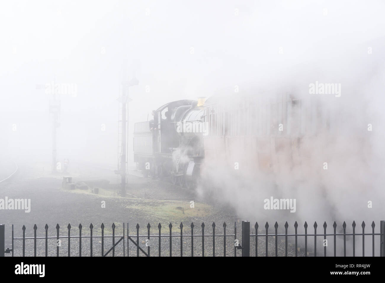 Kidderminster, UK. 24th February, 2019. UK weather: despite the thick morning fog across Worcestershire, nothing dampens the spirit of the dedicated volunteers at Severn Valley Railway. The misty morning provides an atmospheric, picturesque start for the departure of today's first vintage steam train. Credit: Lee Hudson/Alamy Live News Stock Photo