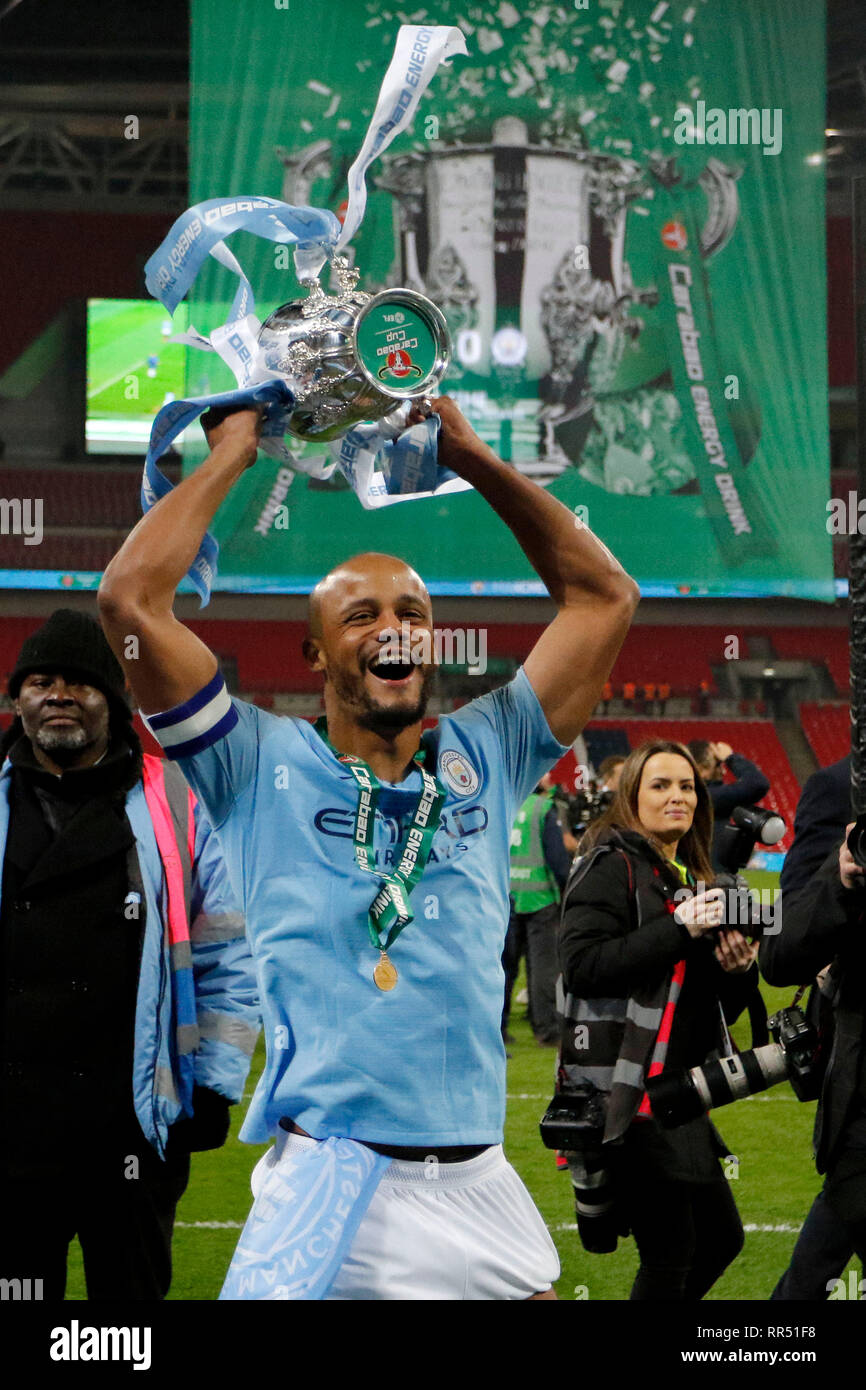 London, UK. 24th Feb, 2019. Vincent Kompany of Manchester City holds the trophy aloft during the EFL Carabao Cup Final between Chelsea and Manchester City at Wembley Stadium, London, England on 24 February 2019. Photo by Carlton Myrie. Editorial use only, license required for commercial use. No use in betting, games or a single club/league/player publications. Credit: UK Sports Pics Ltd/Alamy Live News Stock Photo