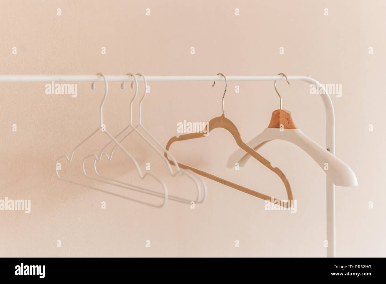 wooden coat hangers on clothes rail. Stock Photo