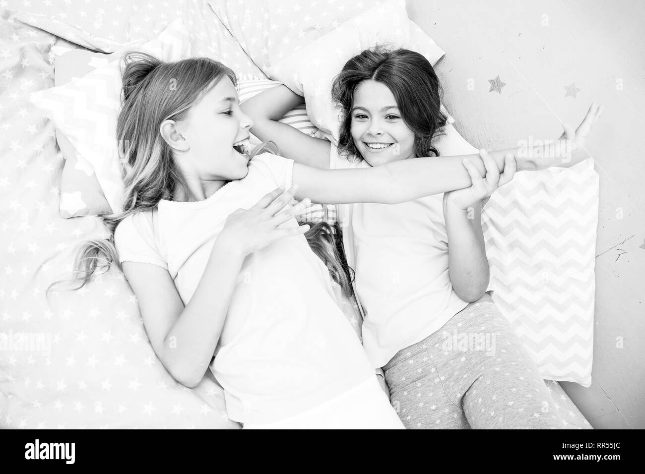Slumber party concept. Girls just want to have fun. Invite friend for sleepover. Best friends forever. Consider theme slumber party. Slumber party timeless childhood tradition. Girls relaxing on bed. Stock Photo