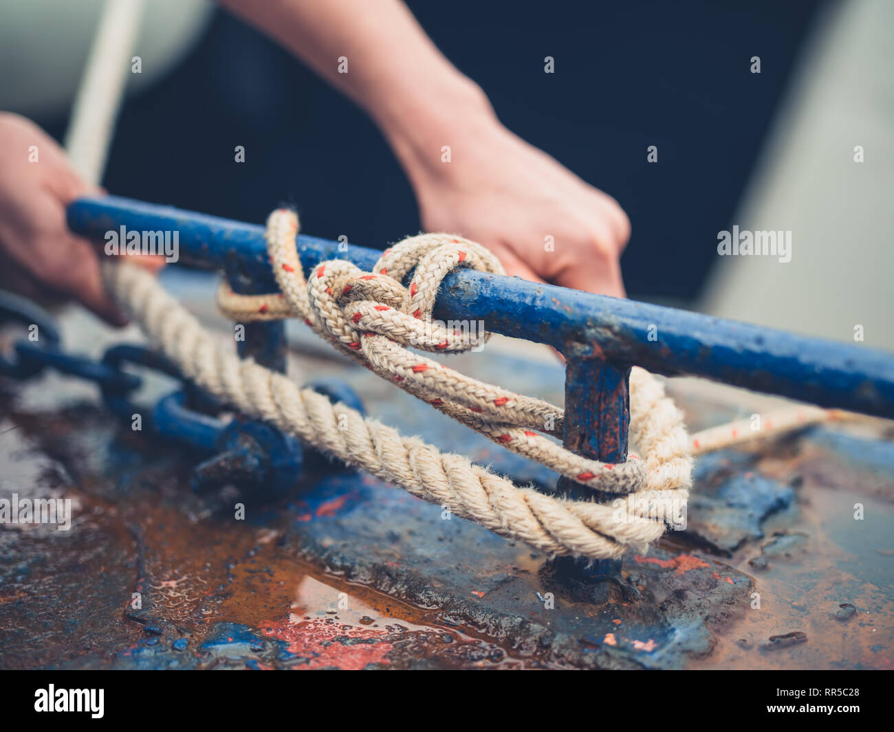 Woman tying rope hi-res stock photography and images - Alamy