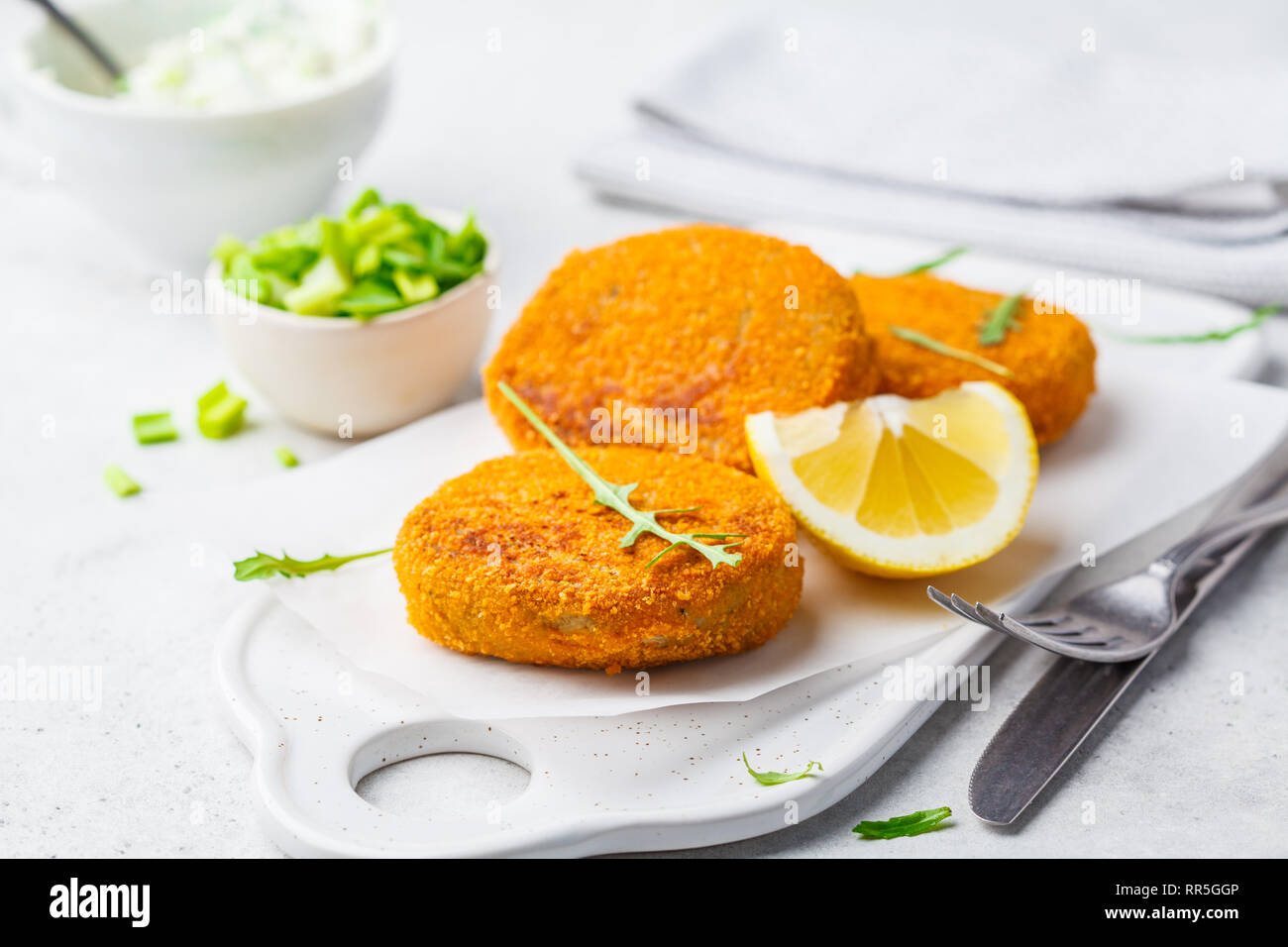 Cooked salmon fish cutlets on a white board. Stock Photo