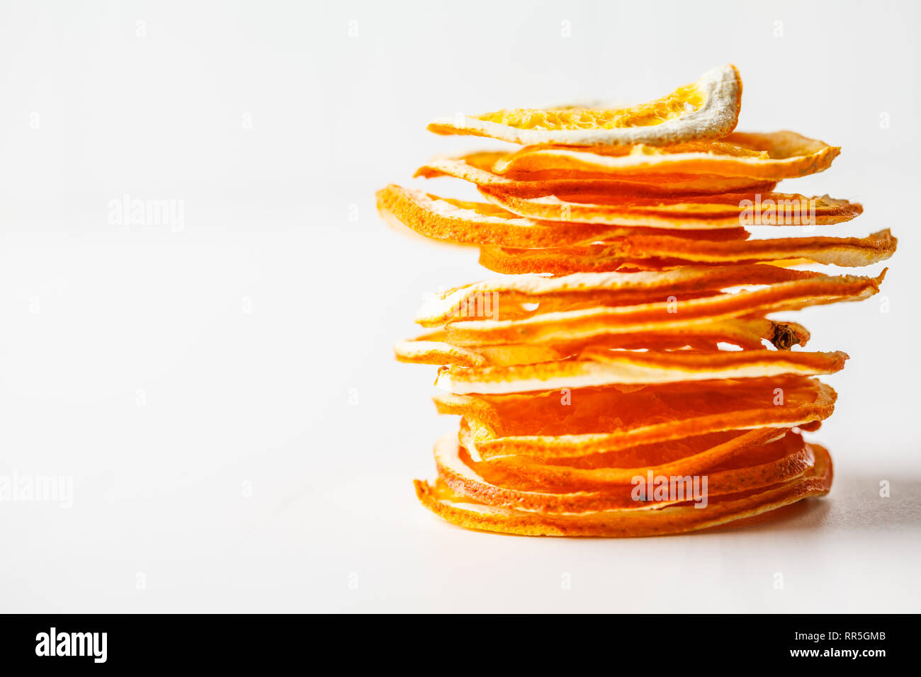 Dried orange chips on a white background Stock Photo Alamy