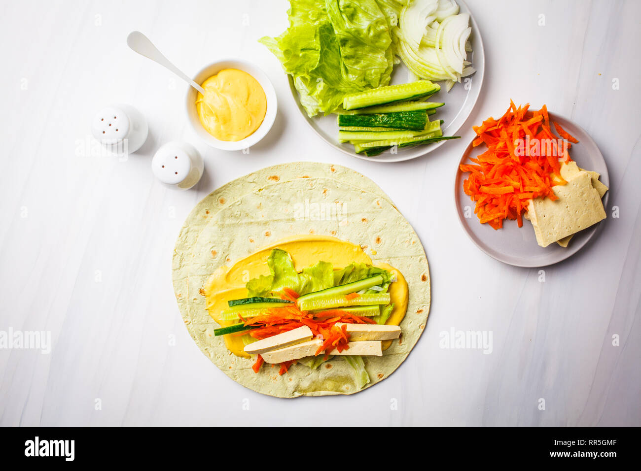 Vegan tofu wraps with cashew cheese sauce and vegetables, white ... Vegan tofu wraps with cashew cheese sauce and vegetables, white ...
