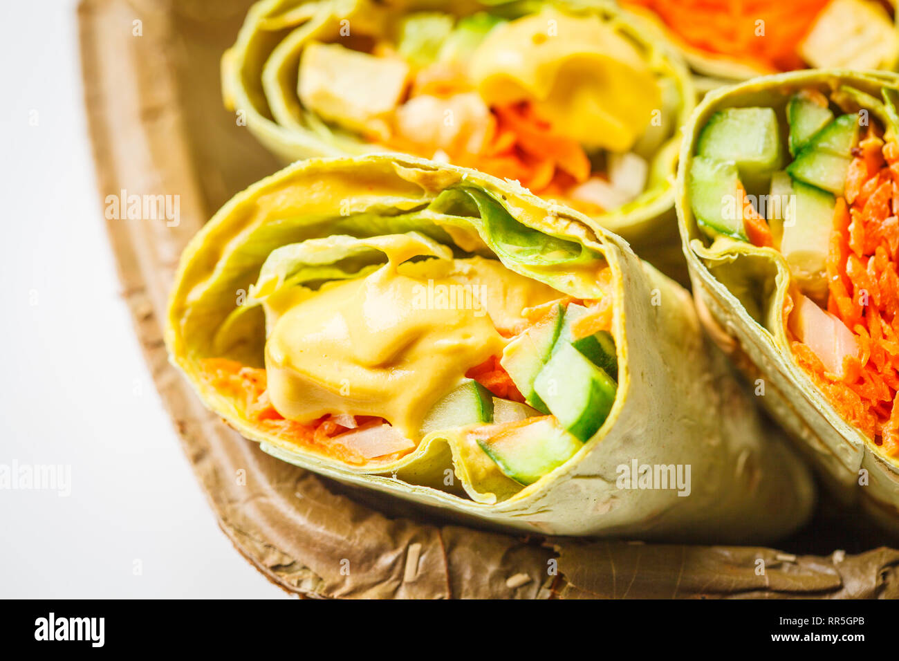 Vegan tofu wraps with cashew cheese sauce and vegetables, white ... Vegan tofu wraps with cashew cheese sauce and vegetables, white ...