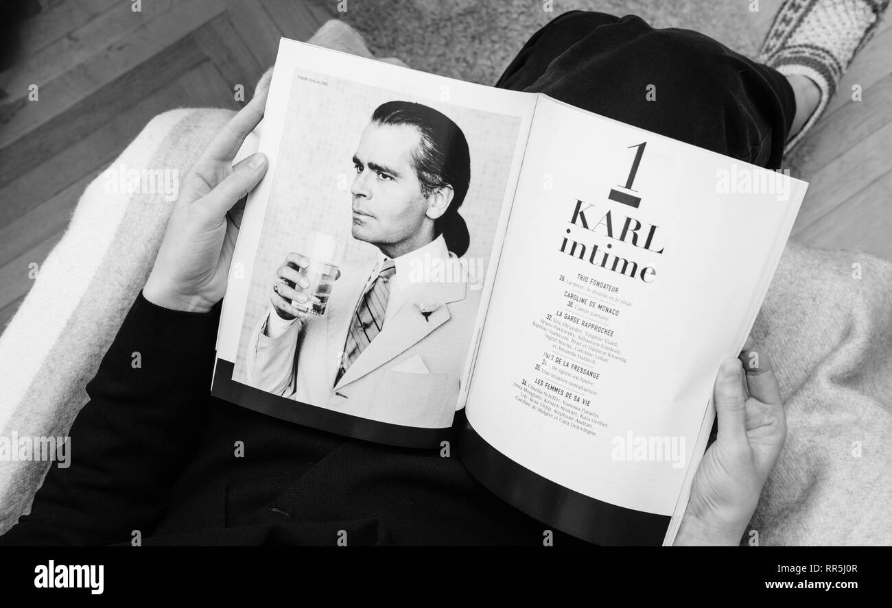 Paris, France - Feb 23, 2019: Woman reading French magazine Karl Lagerfeld death, iconic fashion designer died aged and was creative director at Chanel fashion houses monochrome Stock Photo - Alamy