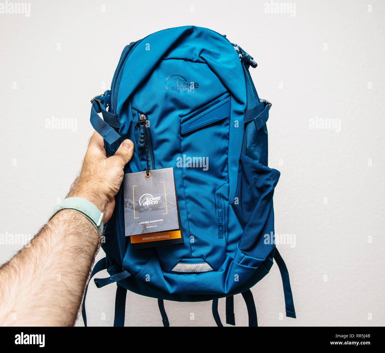 Paris, France - May 30, 2018: Male hand demonstrating against white  background new blue backpack made by Lowe Alpine with Lifetime Guarantee  tag Stock Photo - Alamy