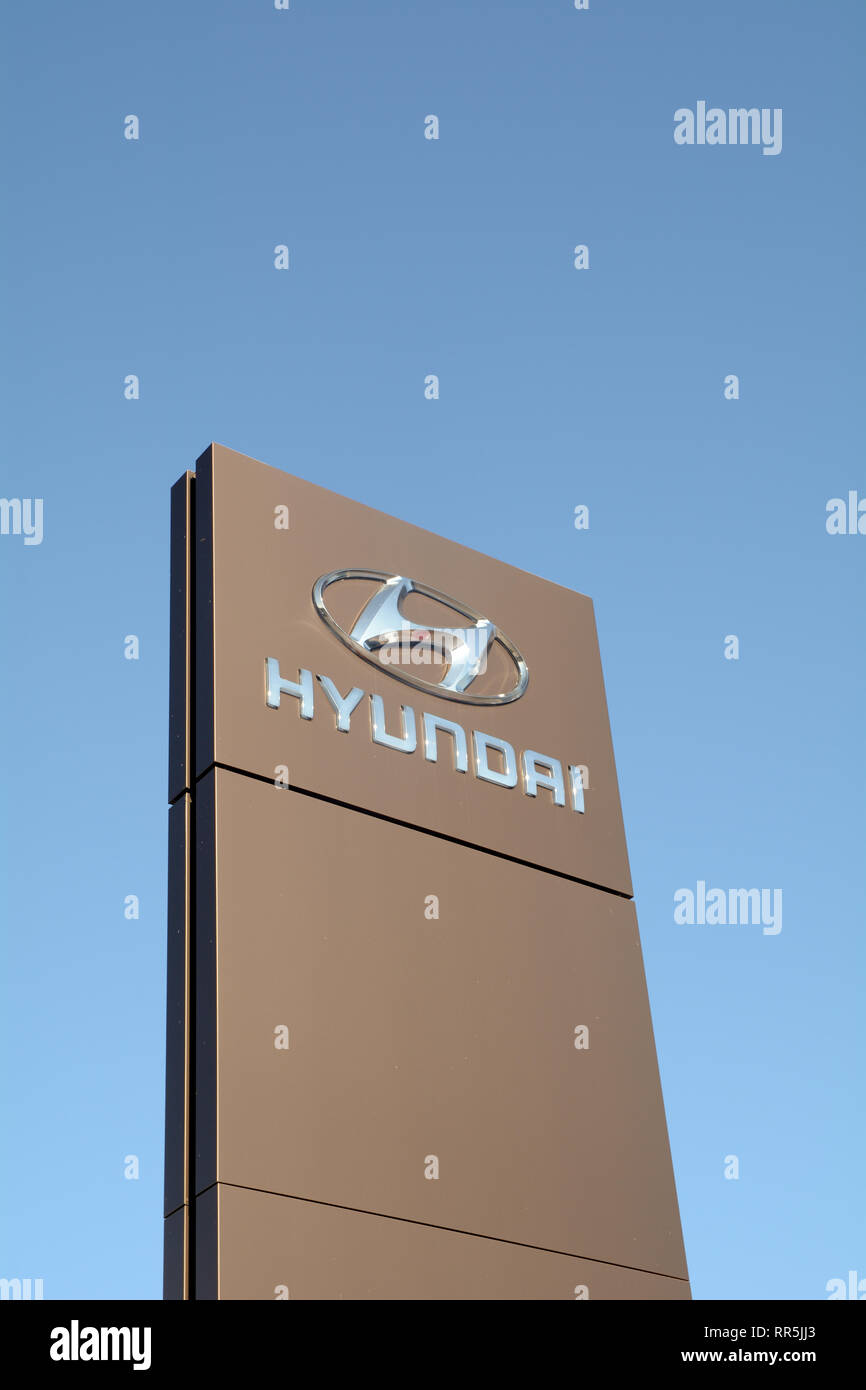 Hyundai car logo sign against blue sky Stock Photo