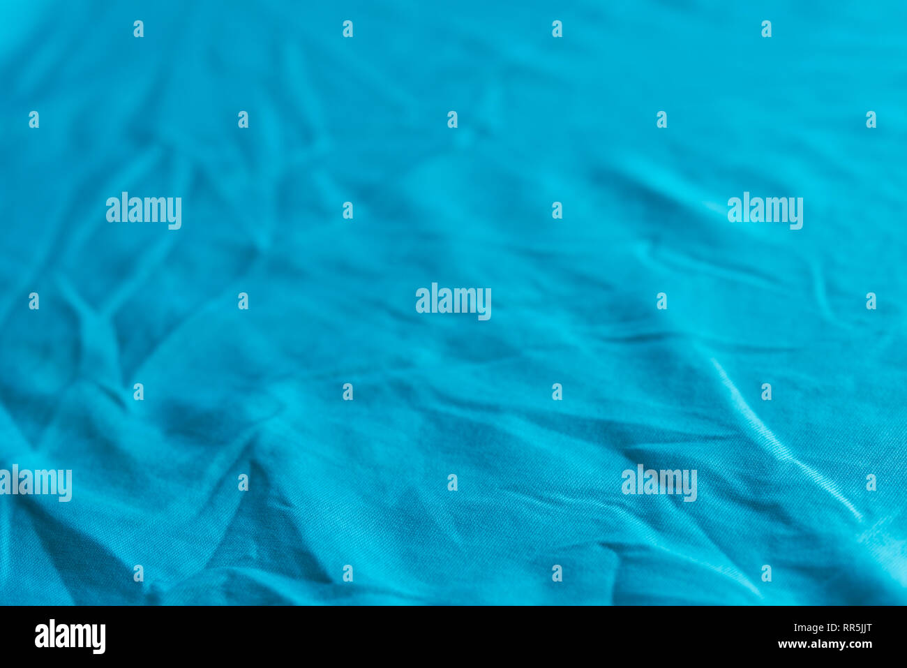 blue color creased textile selective focus background Stock Photo
