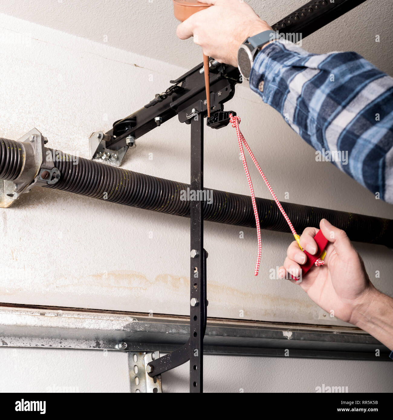 Metal can of oil is used to lubricate a release leaver for a garage door Stock Photo