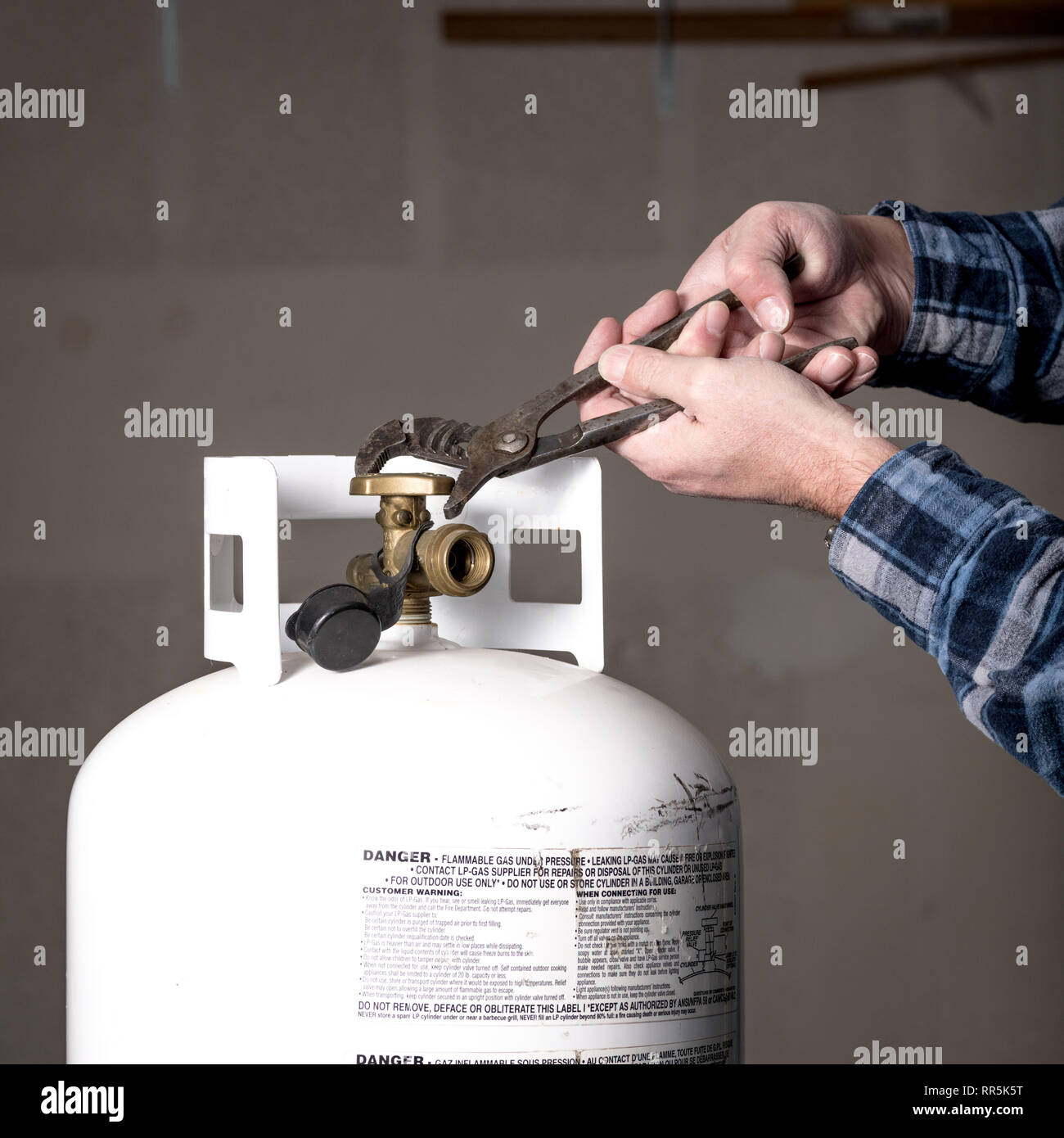 Sticky valve on a propane tank using pliers to Stock Photo Alamy