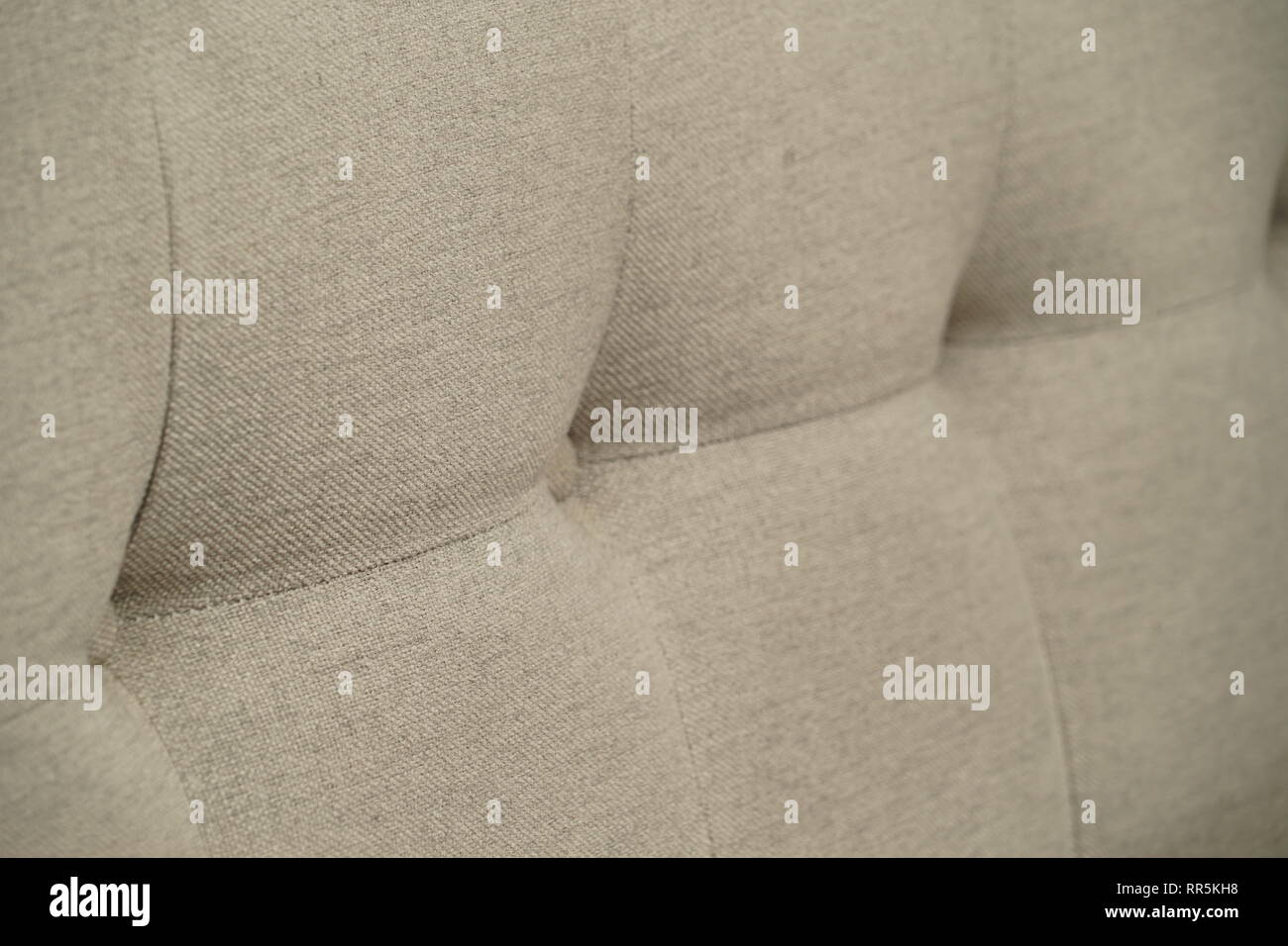 Grey fabric sofa, close up detail with buttons Stock Photo
