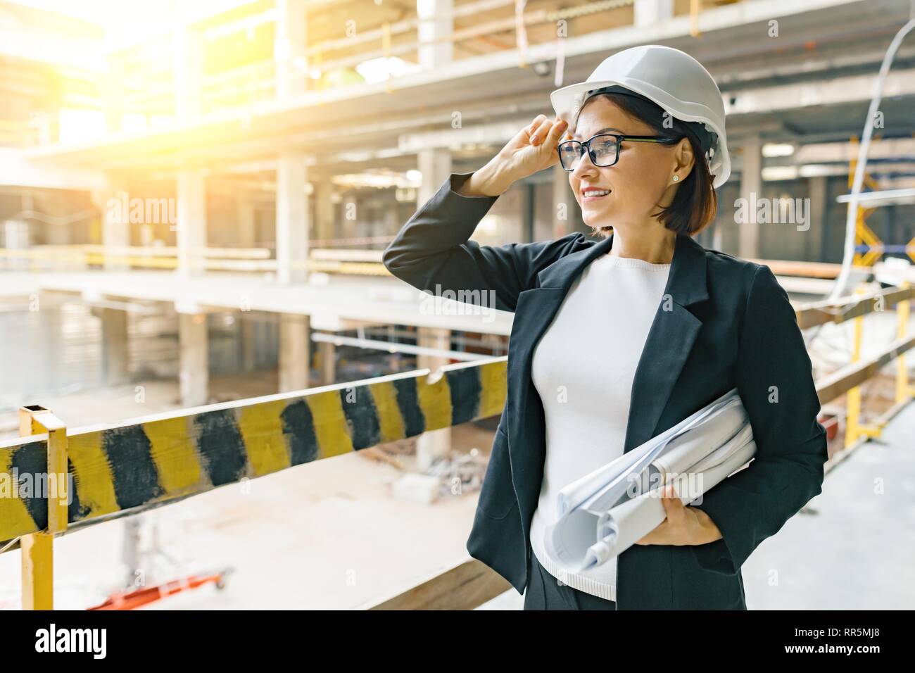 Portrait Of Adult Female Builder Engineer Architect Inspector Manager At Construction Site