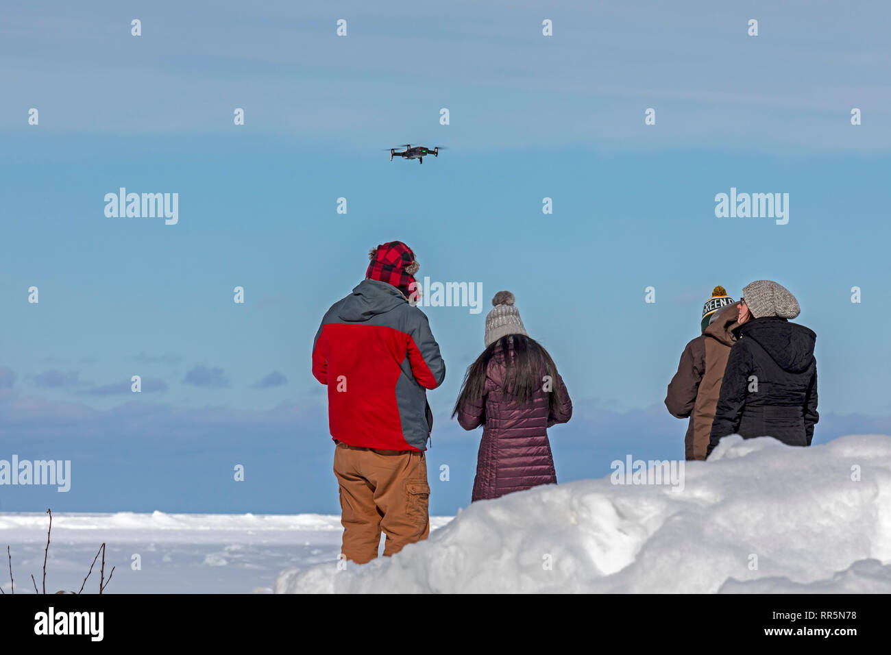 Munising, Michigan - A man illegally flies a drone at the edge of Lake Superior in Pictured Rocks National Lakeshore. Drones are not permitted in U.S. Stock Photo