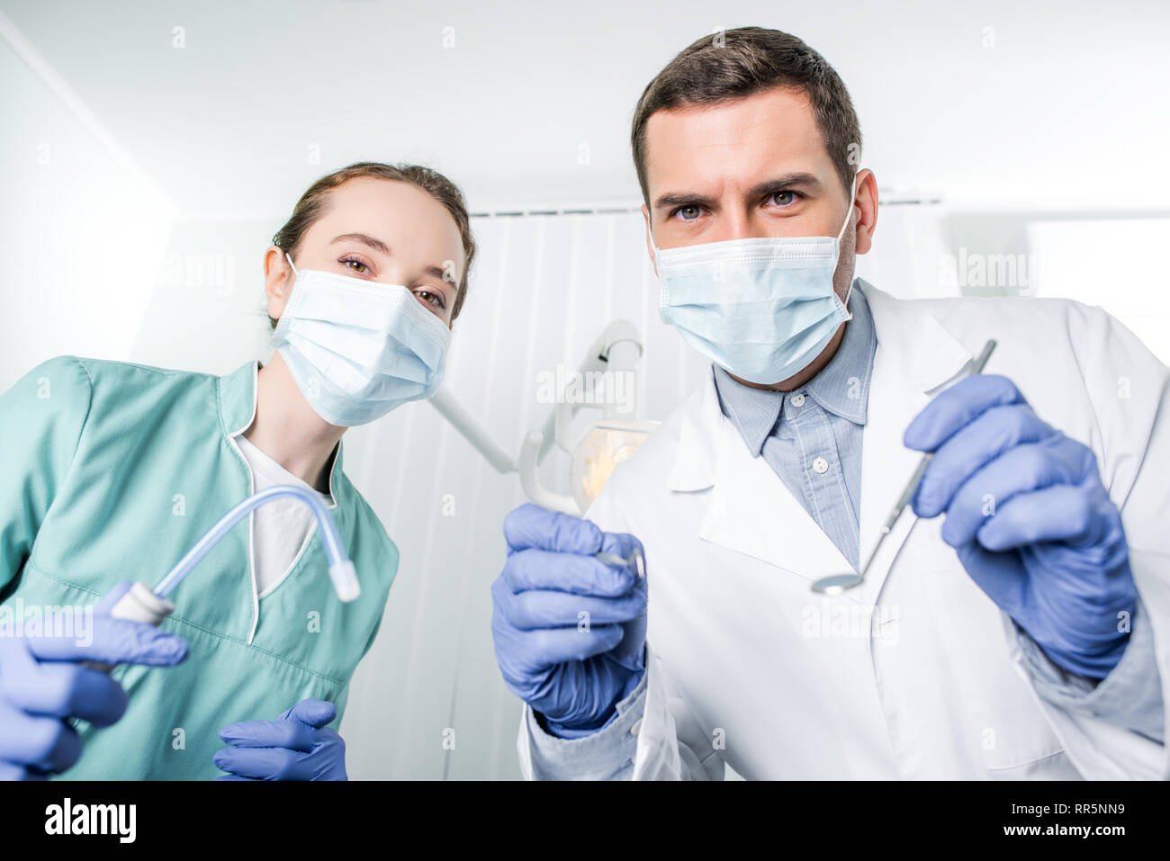 dentists in masks holding dental instruments in hands Stock Photo Alamy