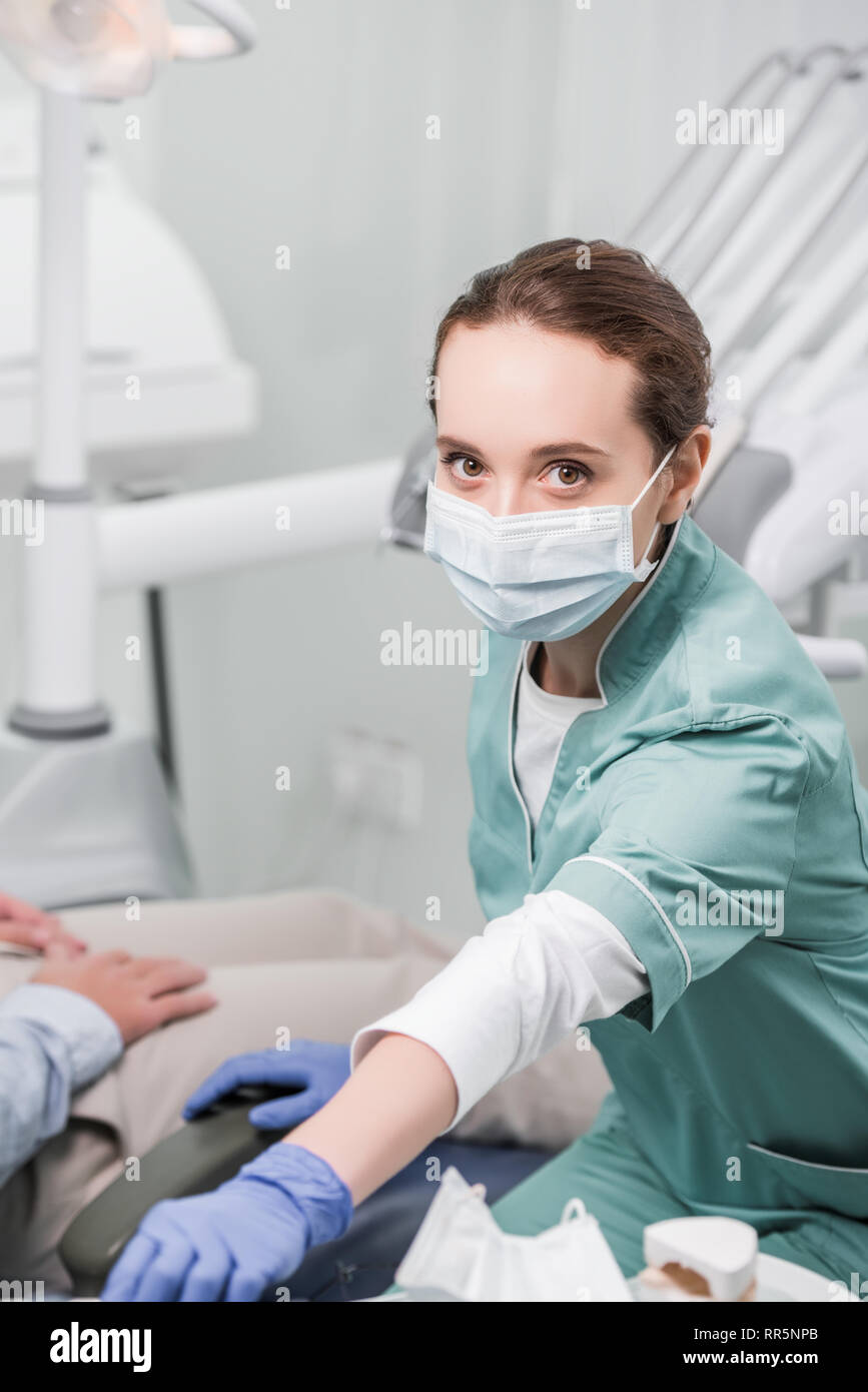 female dentist in mask and latex gloves near patient Stock Photo - Alamy