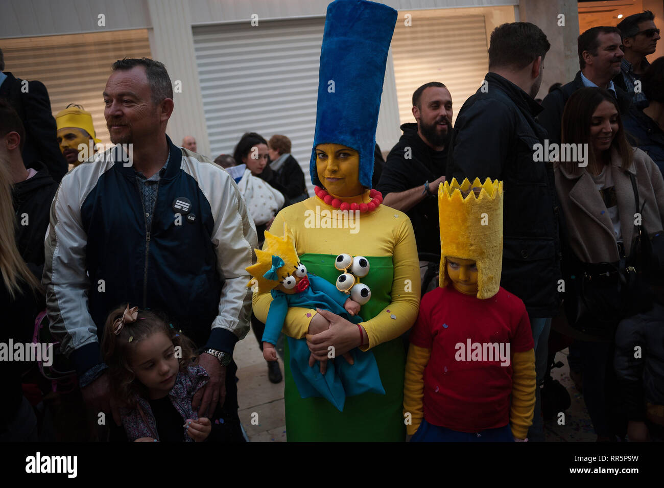 A family seen dressed as characters from the TV serie 'The Simpsons' are seen on the street during the traditional carnival parade that celebrates the carnival festivities in the capital. Stock Photo