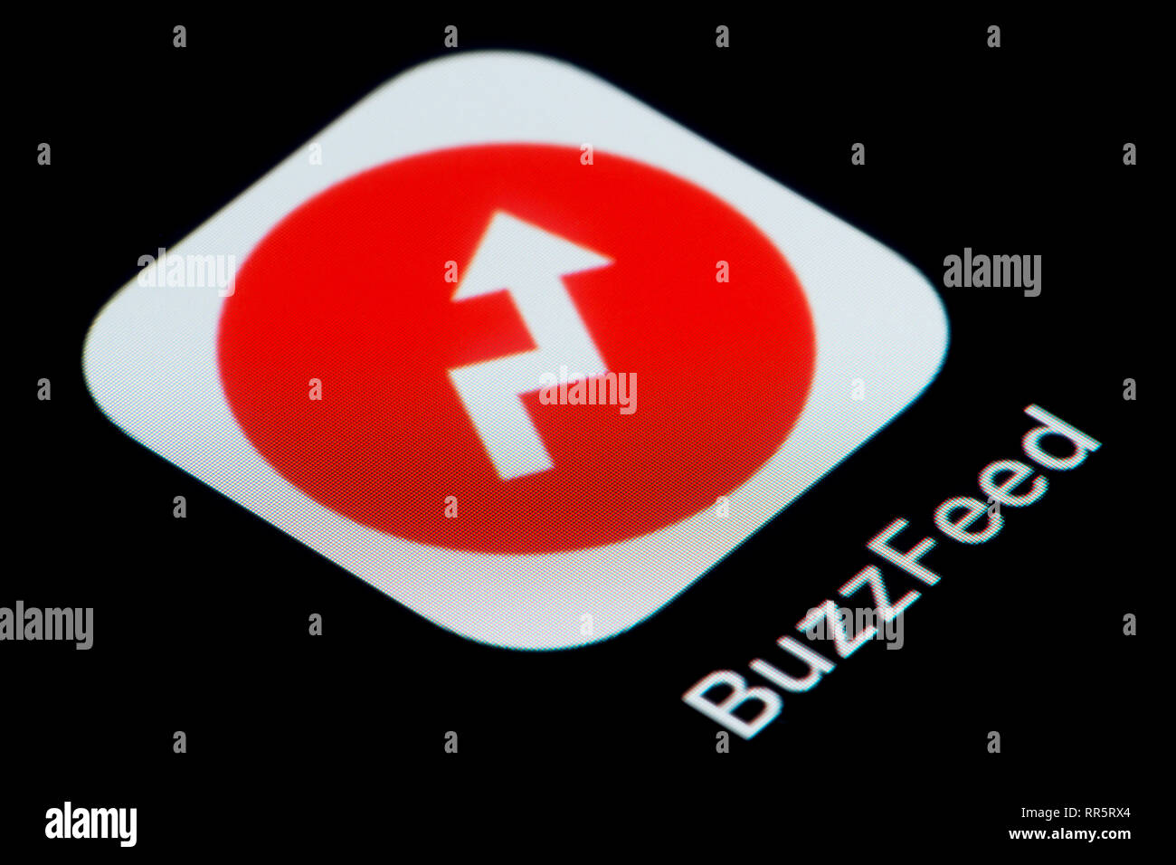 A close-up shot of the Buzzfeed app icon, as seen on the screen of a smart phone (Editorial use only) Stock Photo