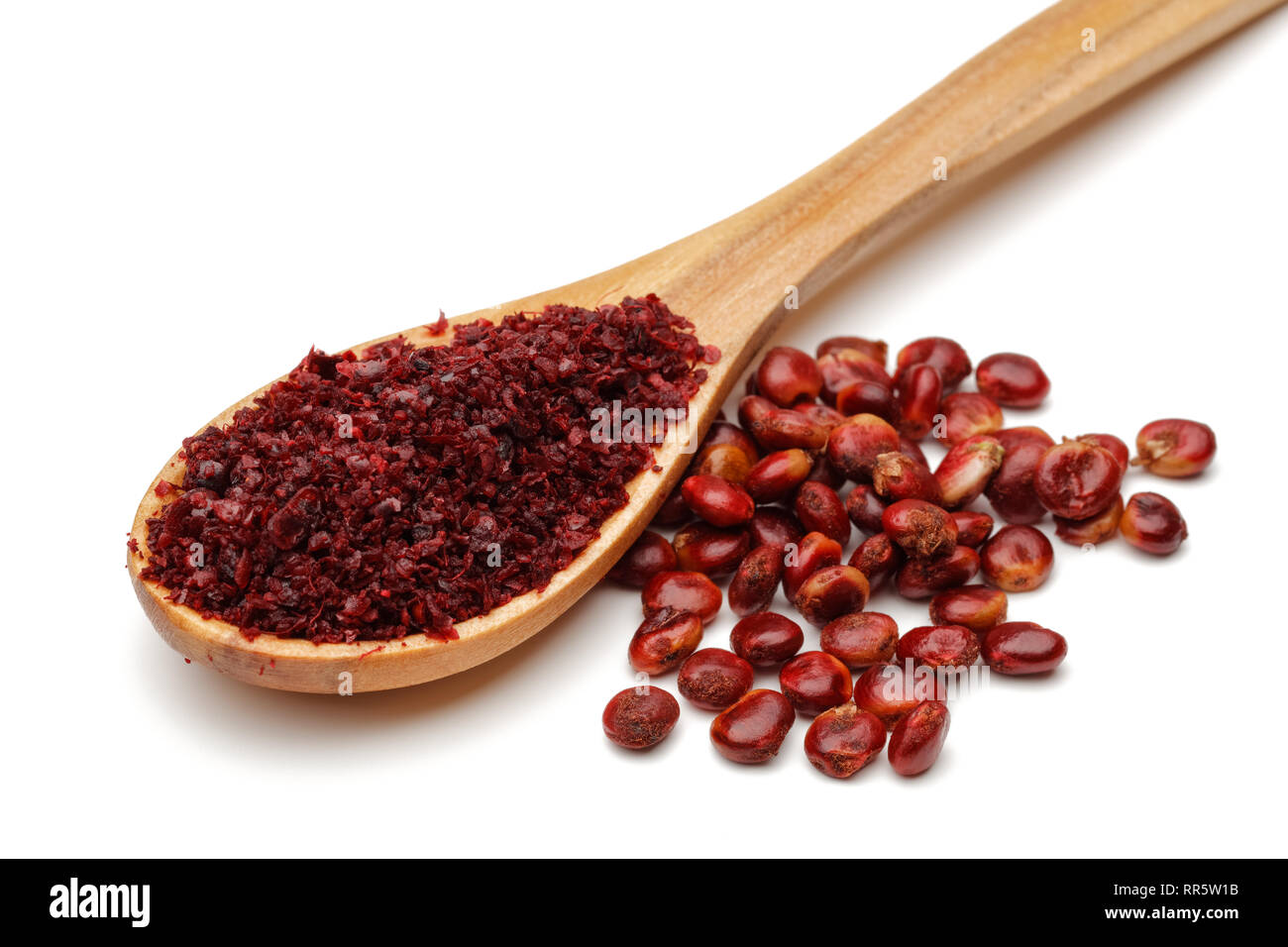 Ground Sumac in wooden spoon and sumac berries isolated on white background Stock Photo Alamy