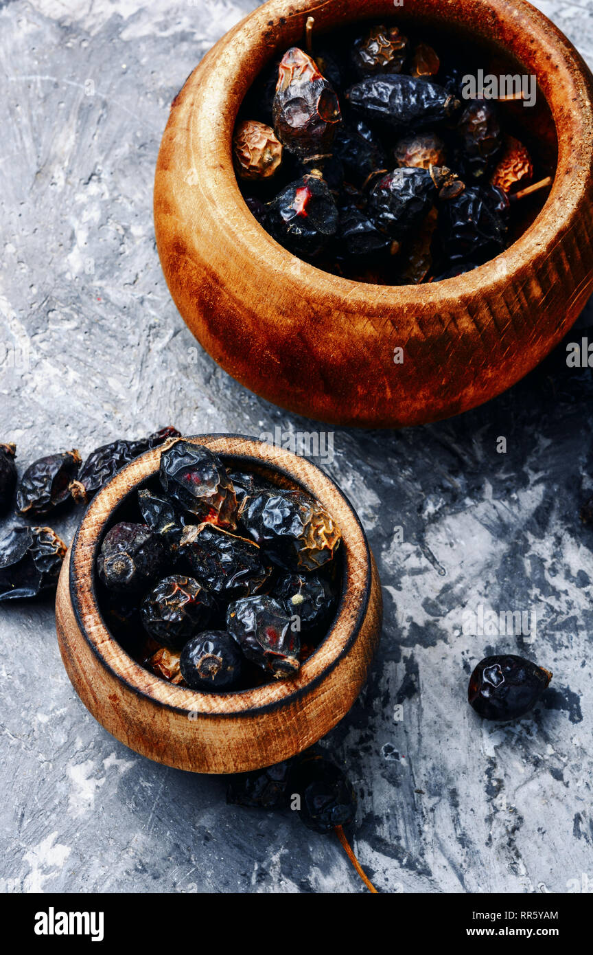 Dried red rose hips in bowl.Medicinal plants Stock Photo