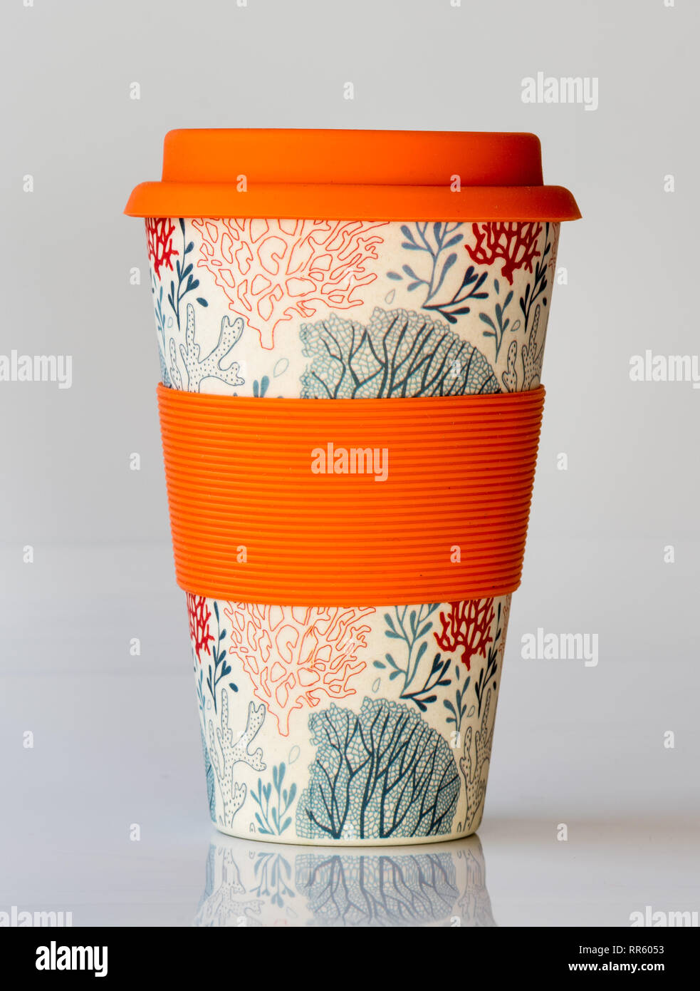 Reusable coffee cup made from natural material with silicone sleeve and lid for a sustainable environment Stock Photo