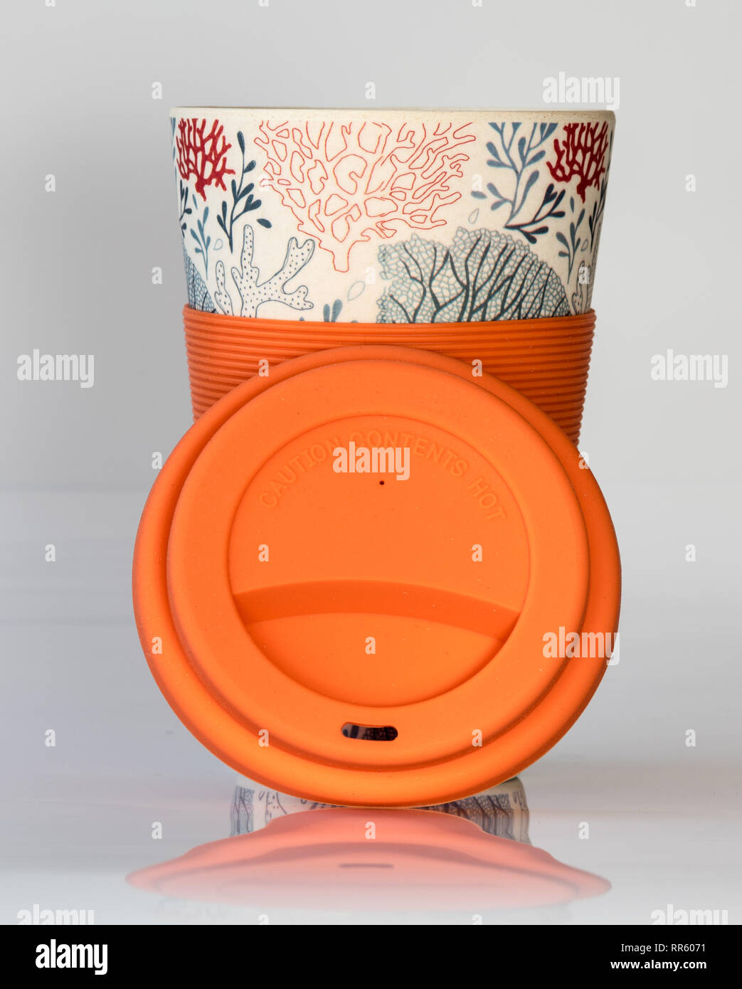 Reusable coffee cup made from natural material with silicone sleeve and lid for a sustainable environment Stock Photo