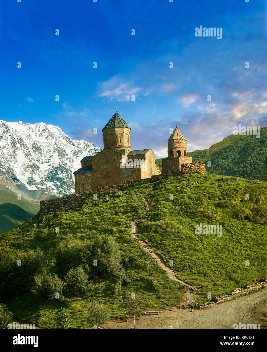 Pictures & images of Gergeti Holy Trinity (Tsminda Sameba) Georgian Orthodox and Apostolic Church and bell tower, 14th century, Gergeti, Khevi provinc Stock Photo