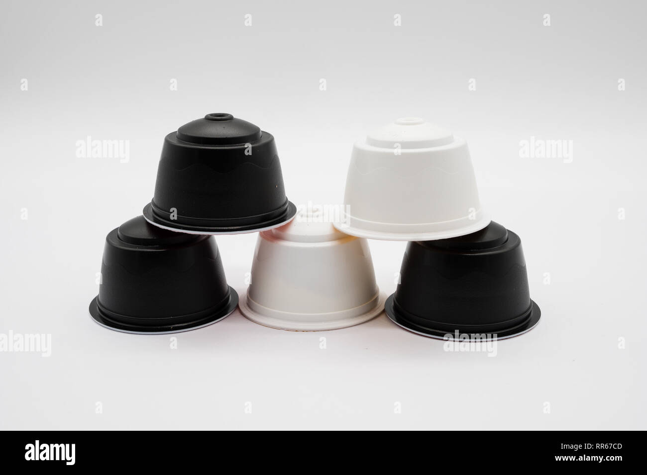 Five coffee refill pods from a modern type home coffee machine on a white background. He pods in