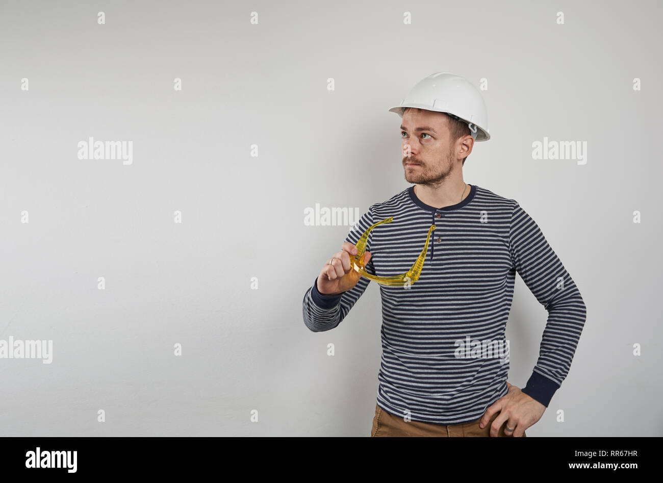 Builder in a helmet on a white background Stock Photo