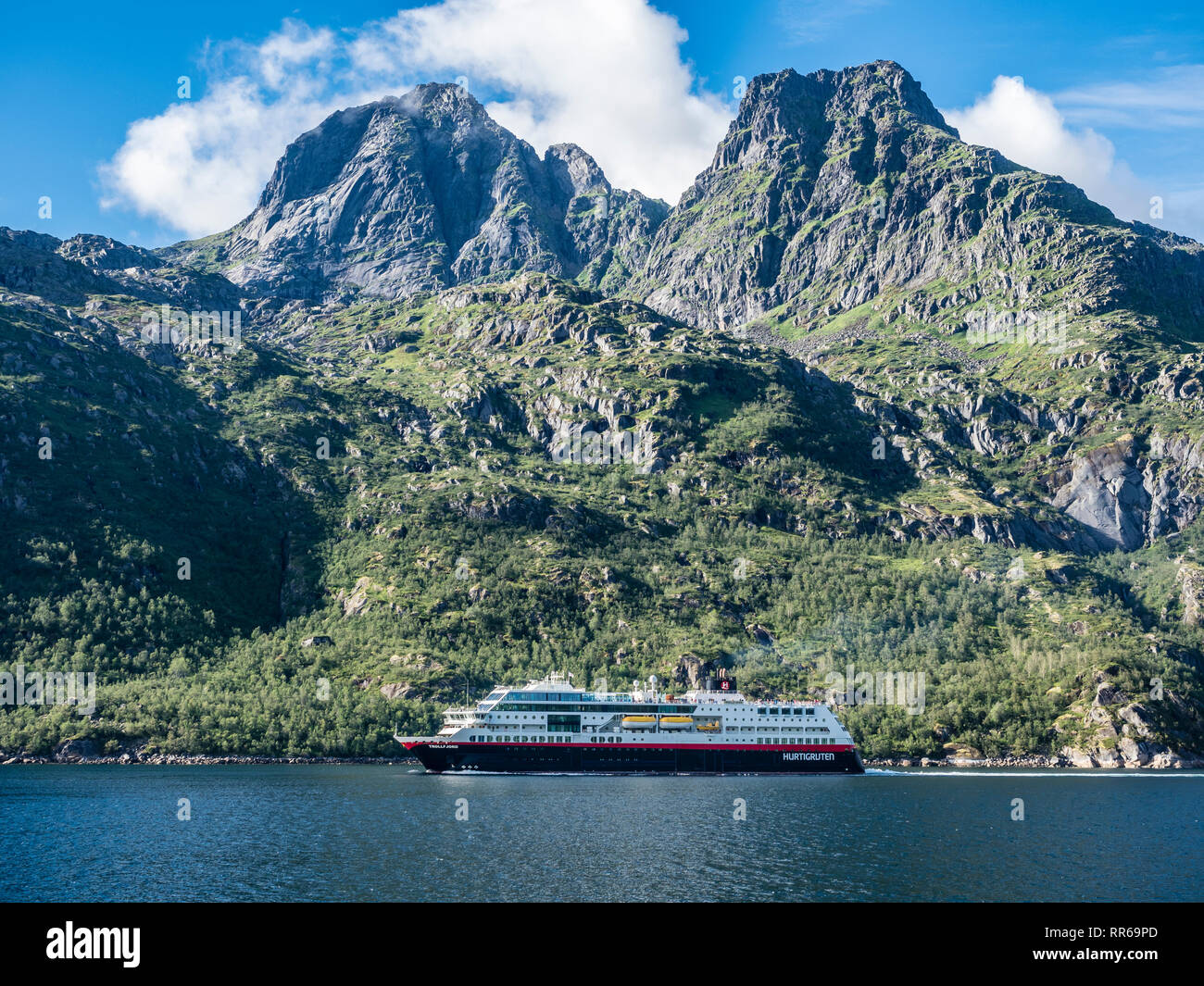 Hurtigruten cruise ship passing the Raftsund on a sunny day, strait between islands  Hinnøya and Austvågøya, Norway Stock Photo