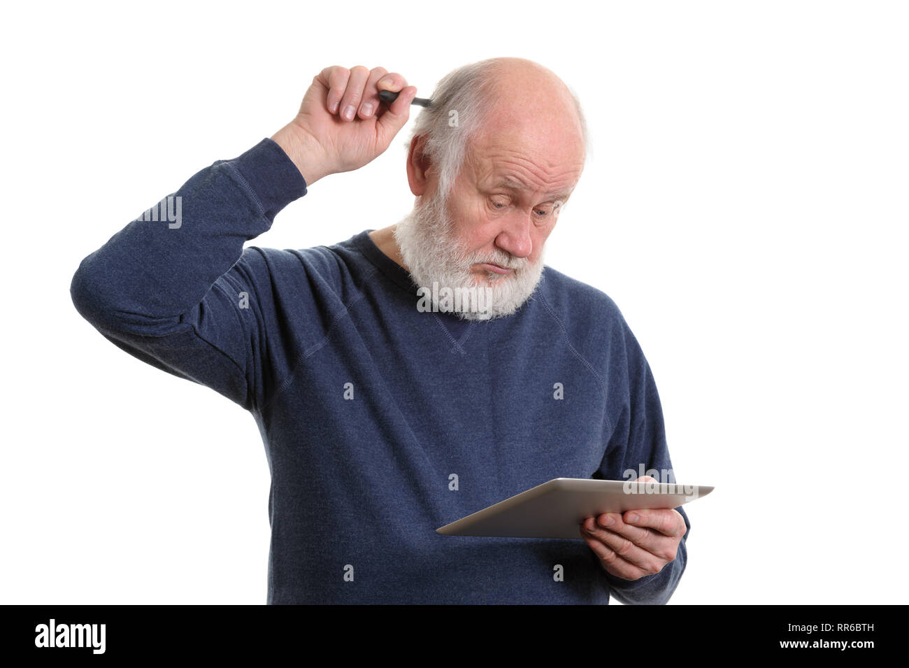 Funny old man using tablet computer and puzzled, isolated on white Stock Photo