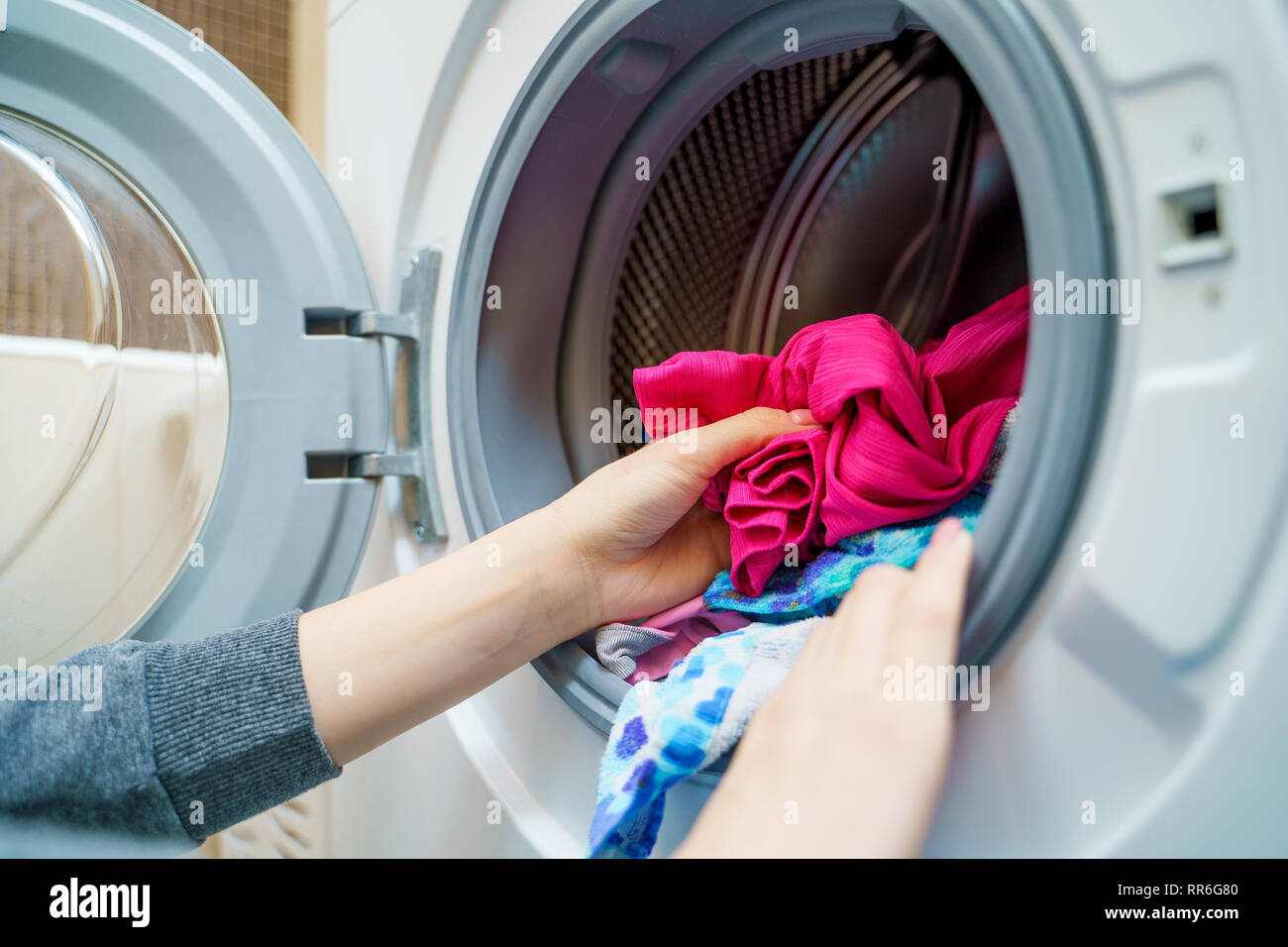 Dirty clothes in washing machine hires stock photography and images