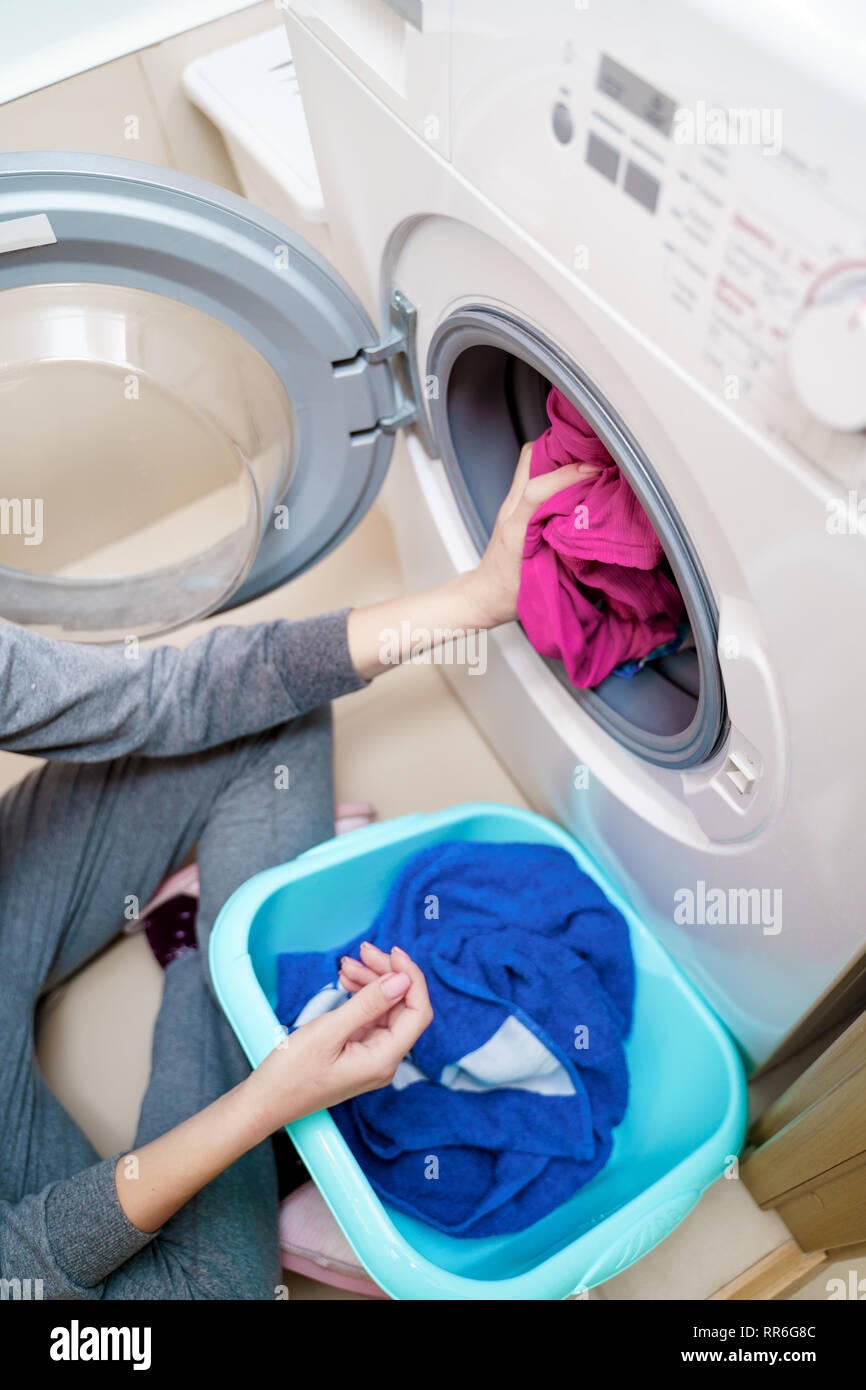 photo-from-above-of-female-hands-putting-dirty-pink-clothes-in-washing-machine-stock-photo-alamy