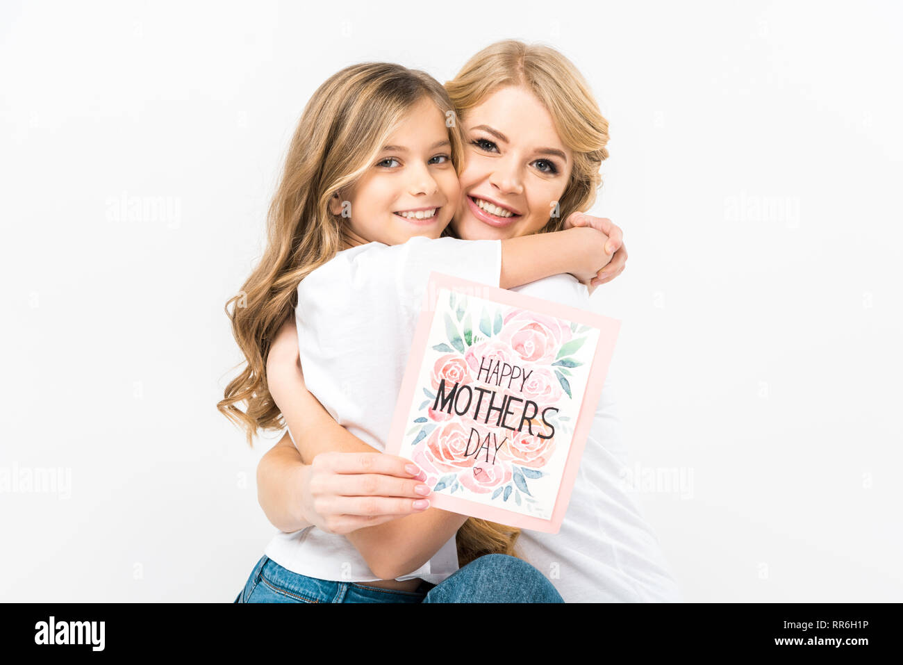 Happy Beautiful Mother Holding Happy Mothers Day Greeting Card And Hugging Adorable Daughter On White Background Stock Photo Alamy