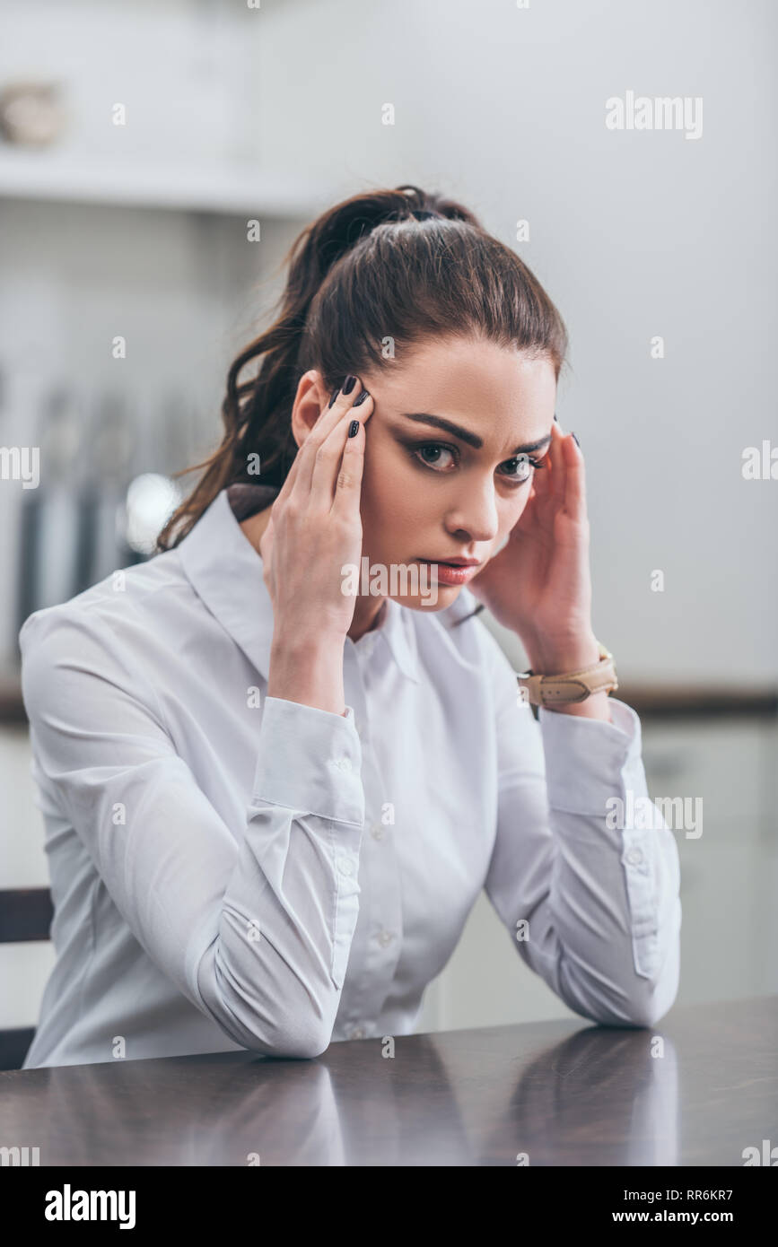 Woman holding hands temples hi-res stock photography and images - Alamy