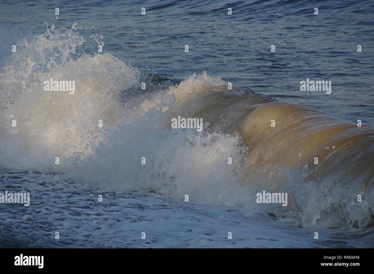 Wave Swashing up Sidmouth Beach on a Summer Evening. East Devon, UK. Stock Photo