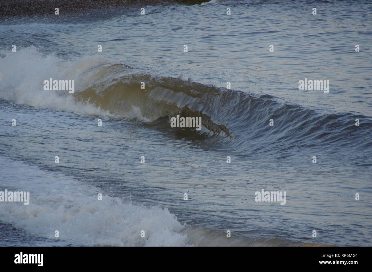 Wave Swashing up Sidmouth Beach on a Summer Evening. East Devon, UK. Stock Photo