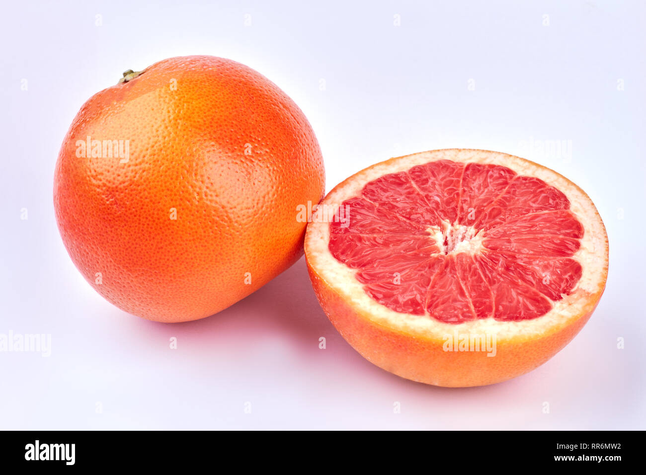 Whole and half of grapefruits Stock Photo Alamy