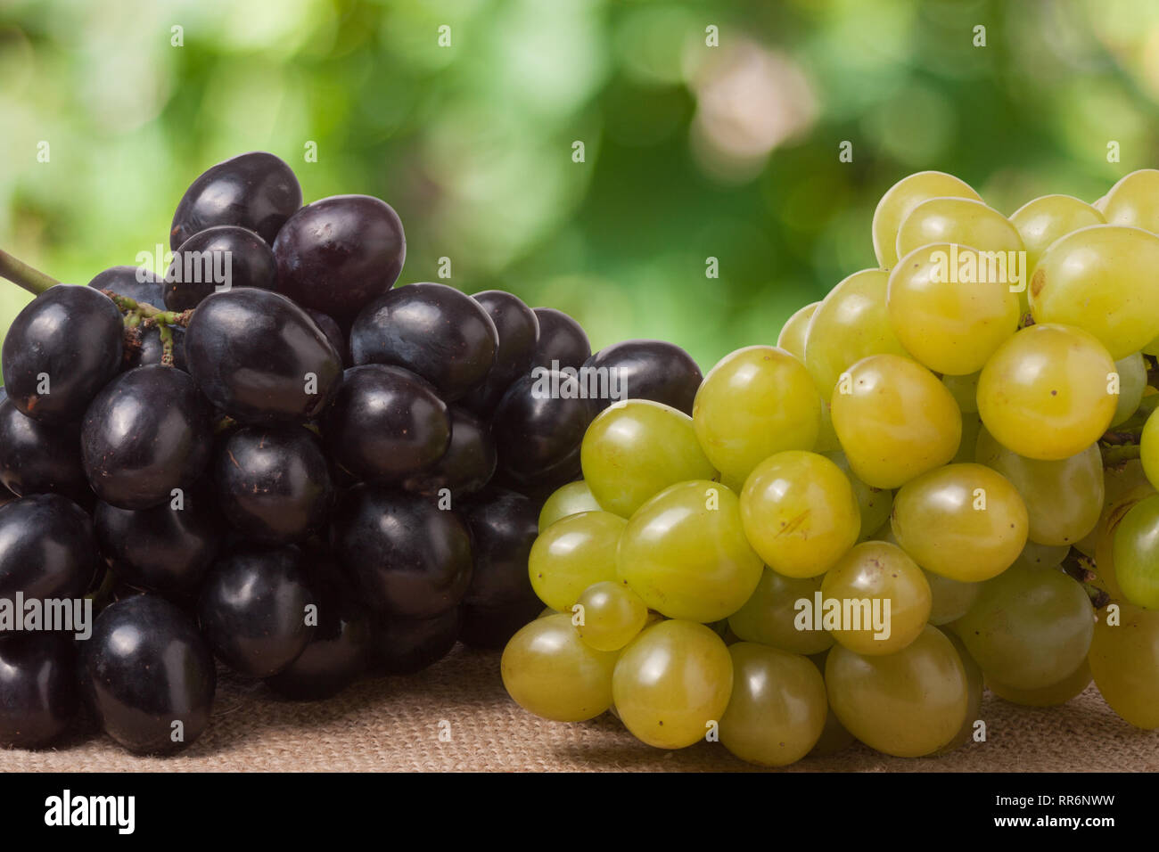 Blue and green grapes on the table with a blurred background Stock Photo