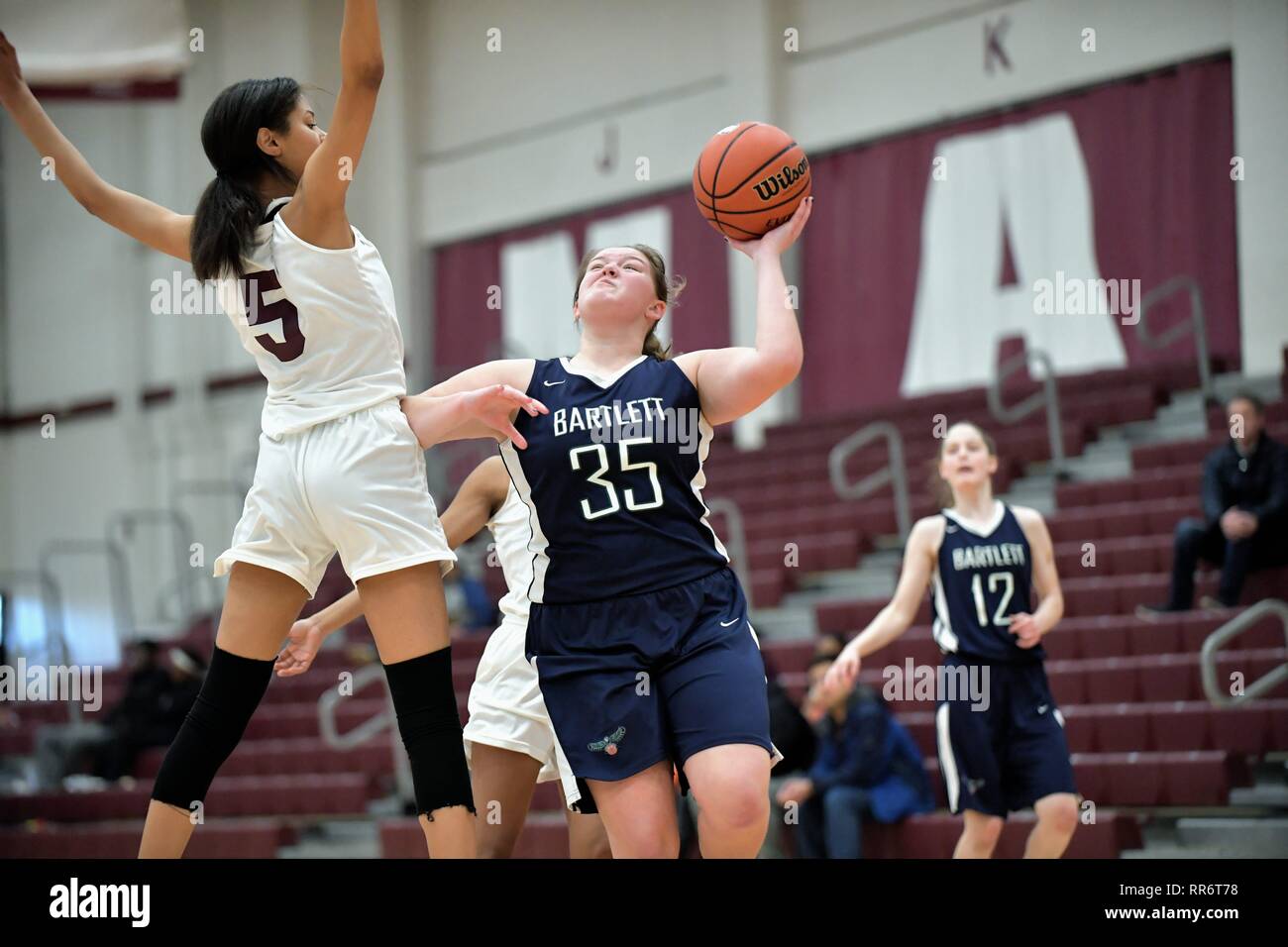 Player attempting a short lefthanded shot over a leaping opponent. USA Stock Photo Alamy