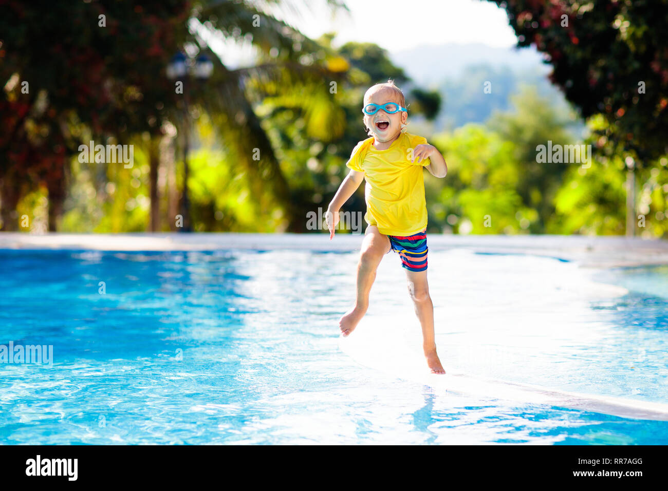 Child Playing In Swimming Pool Summer Vacation With Kids Little Boy Jumping Into Water During Exotic Holiday In Tropical Island Resort Children Swi Stock Photo Alamy