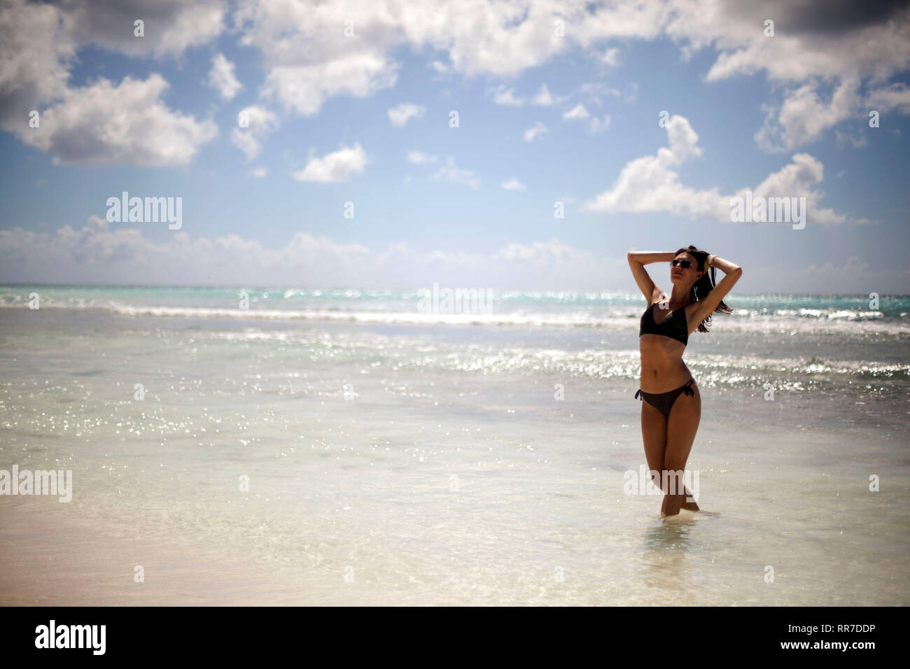 Attractive woman in bikini on tropical beach Stock Photo