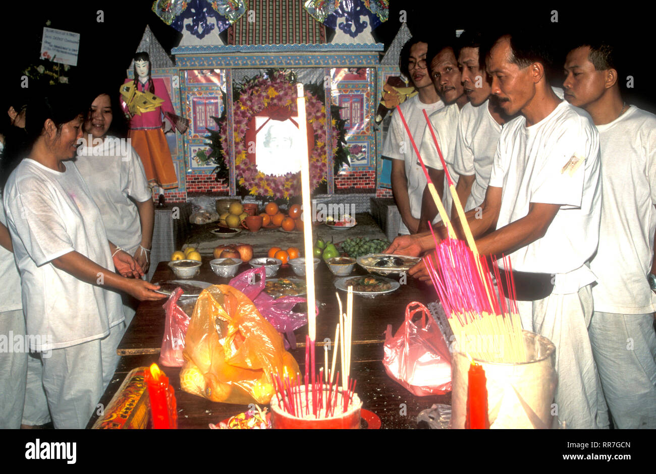 Chinese funeral with family members and offerings in Malacca Malaysia Stock Photo