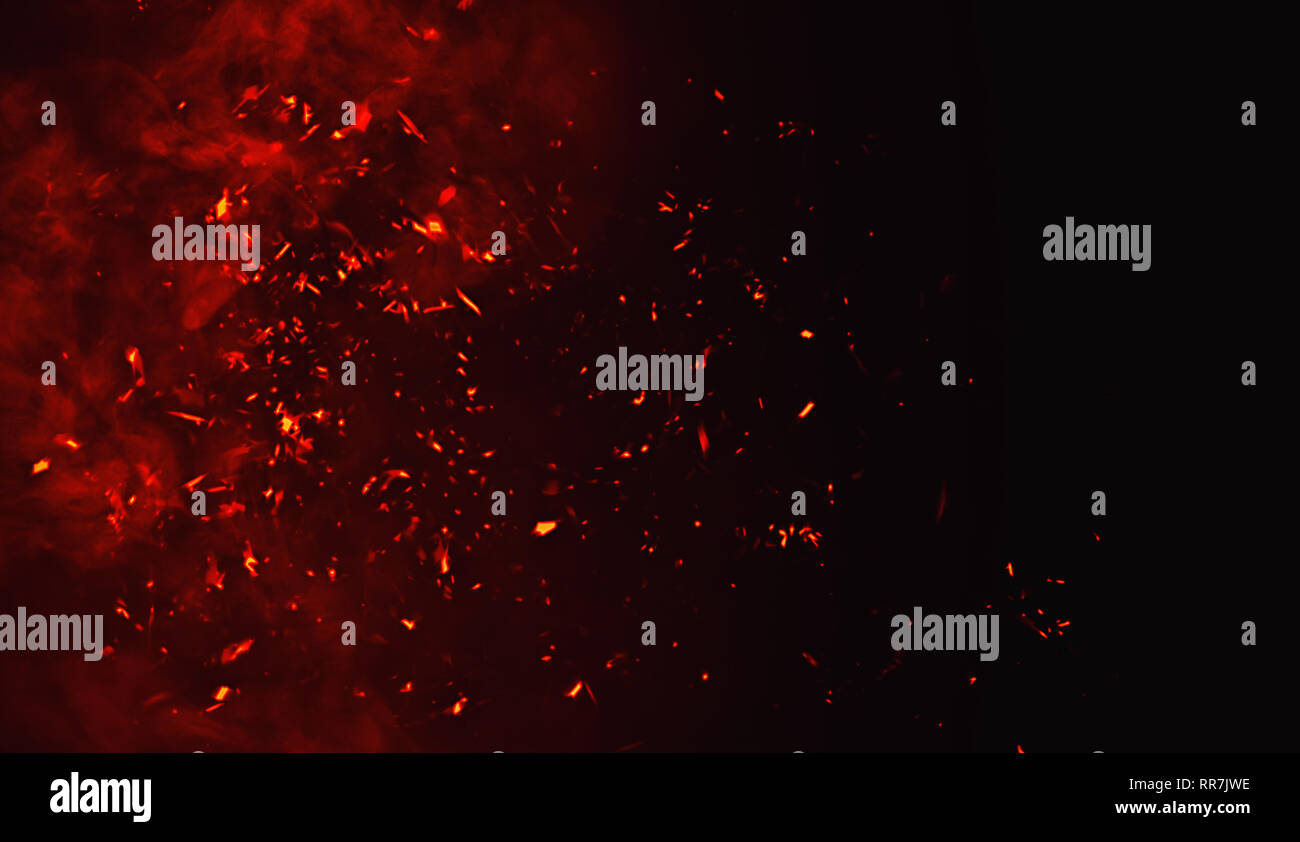 Fire particles debris isolated on black background for text or space . Film texture effect. Stock Photo