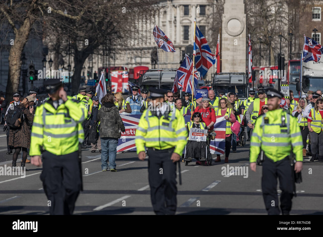 Pro-Brexit protesters calling themselves the 'Yellow Vests UK' movement block roads and traffic whilst protest marching through Westminster, London. Stock Photo