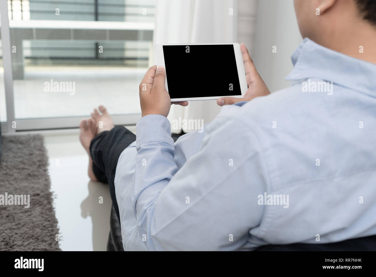 Man hand holding the black smartphone screen mockup Stock Photo